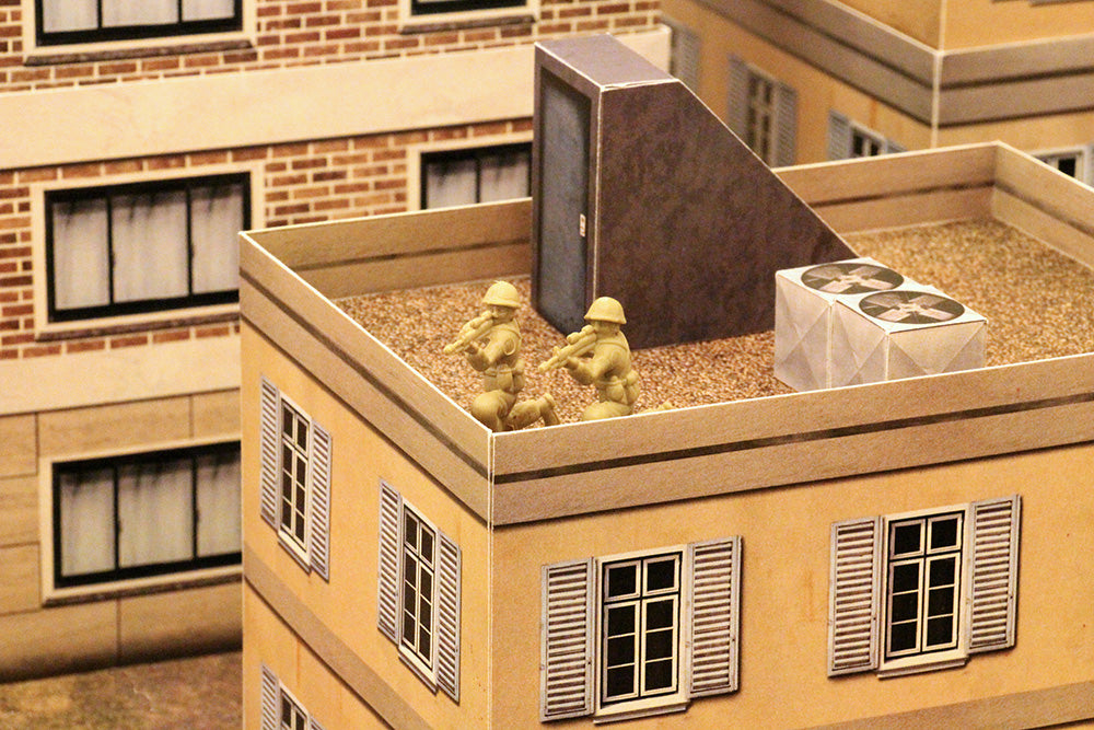 tan plastic army men on top of a building in a sniper configuration, taking aim at a target